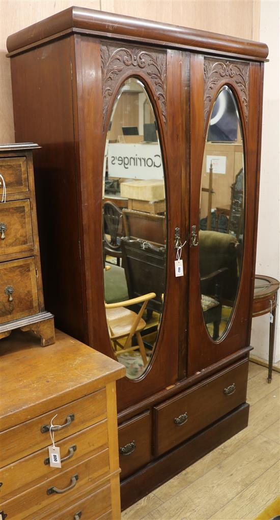 An Edwardian mahogany two door mirrored wardrobe W.109cm